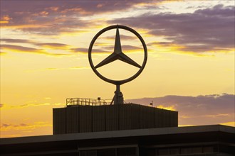 Mercedes star on building in front of evening sky, after sunset, Stuttgart-Untertürkheim,