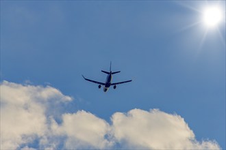 Passenger plane in front of cloudy sky, sun, sunbeams, Baden-Württemberg, Germany, Europe