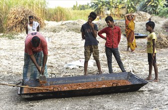 Workers making Gur (jaggery) in a village on December 10, 2021 in Barpeta, Assam, India. Gur