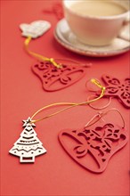 Christmas or New Year composition. Decorations, fir and spruce branches, cup of coffee, on a red