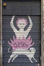 Graffiti on a closed shutter in the historic centre, Genoa, Italy, Europe