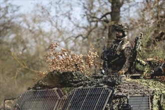 A Czech soldier occupies the hatch of an armoured vehicle as part of the military exercise