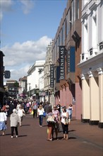 Shoppers walking in a pedestrianised shopping area in the town centre of Ipswich, Suffolk, England,