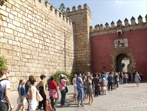 Line of tourists queueing to enter the Alcazar in Seville, Spain, Europe