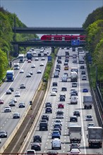 S-Bahn train, crossing the motorway A3, traffic on 8 lanes, incl. the temporarily released hard