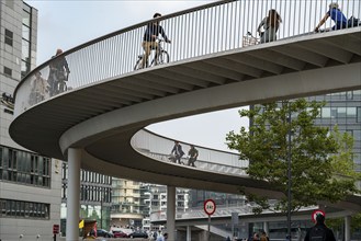 Cyclists on the Cykelslangen cycle and pedestrian bridge, at the Fisketorvet shopping centre,