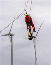 Height rescuers from the Oberhausen fire brigade practise abseiling from a wind turbine from a