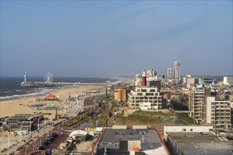 View over the beach of Scheveningen, the pier with Ferris wheel and the skyline of the town, which