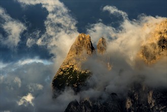 Sunset and mountain peaks in the clouds, Catinaccio, Dolomites, South Tyrol, Trentino-Alto Adige,