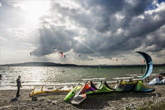 Kitesurfers and windsurfers in sun and storm, Reichenau Island, Untersee, Lake Constance,