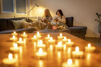 Symbolic image energy saving, cold winter, energy crisis, cold flat, mother and daughter lying on