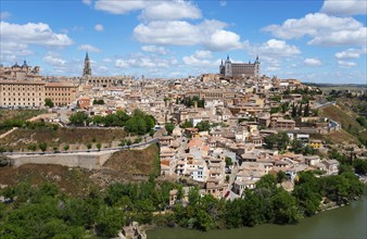 Expansive view of a historic city on a hill with a river and many architectural highlights, Toledo,