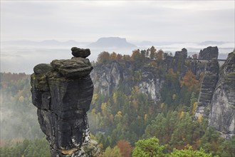 View over the rock tower Wehlnadel and the valley Wehlgrund in autumn, Saxon Switzerland,