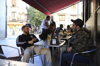 People drinking outside, Cerveceria 100 Montaditos chain bar pub, Madrid city centre, Spain, Europe