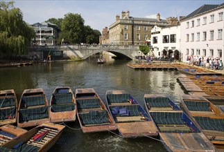 People punting in small boats on the River Cam near Silver Street Bridge, Cambridge, England,