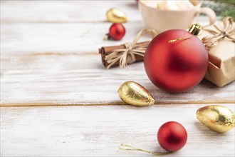 Christmas or New Year composition. Decorations, box, red balls, cinnamon, fir and spruce branches,