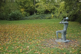 Flute player by Walter Wadephul 1965 in autumn, park, lawn, fallen leaves, leaf fall, autumn, spa