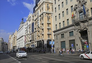 Traffic historic buildings busy road of Gran Via, Madrid city centre, Spain, Europe