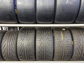 Shelf with racing tyres Car tyres Tyres for car racing top Slicks without tread Tyre tread for dry