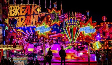 Breakdance fair ride at night with colourful lights, Cannstatter Wasen, Bad Cannstatt, Stuttgart,