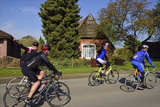 Landhaus, Niedersachsen, Reetdach, Radfahrer im Gang, Sport