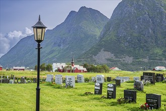 Graveyard of Flakstad, Flakstad church in the back, red wooden building, Flakstad, Lofoten, Norway,