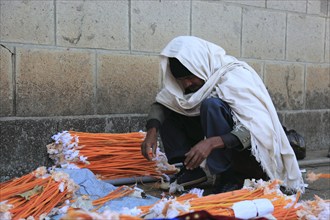 Europia district, Debre Lebanon, Lipanus monastery, man sorting wax torches for the pilgrims at the