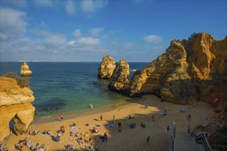 Rocky coast with beach and red rocks, Praia do Camilo, Lagos, Algarve, Portugal, Europe