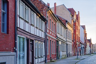 Half-timbered houses in the street Altes Dorf, a street with cobblestones, in the old town centre