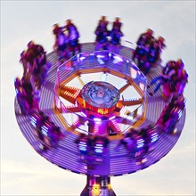 People on the illuminated carousel Mr Gravity in motion, Cranger Kirmes, Herne, Ruhr area, North