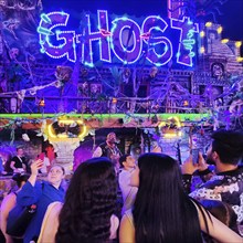 People in front of the illuminated ghost train Ghost in the evening, Cranger Kirmes, Herne, Ruhr