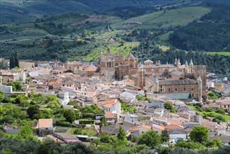 Views of the old town centre with characteristic architecture and green hills in the background,