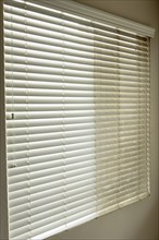 Residential window shades showing the before and after of a good cleaning, one side clean and one