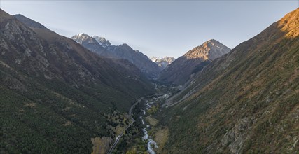 Aerial view, mountain stream Ala Archa flows through the Ala Archa valley, autumnal mountain