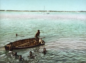 Diving for coins, Nassau, Bahama Islands, digitally restored reproduction from a 19th century