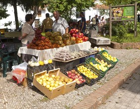 Selling chestnuts at a fruit and vegetable market stall in the village of Galaroza, Sierra de