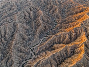 Landscape of eroded hills at Lake Issyk Kul, Badlands at sunrise, aerial view, Canyon of the