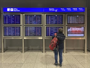 Elderly woman, best ager, standing in front of departure board, departure board, Terminal 2,