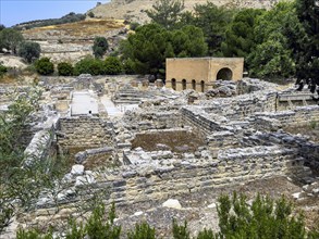 View of foundation walls behind ruins of historic Roman amphitheatre from antiquity in excavation