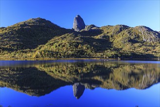 Mountains reflected in lake, morning light, sunny, autumn, Vesteralen, Norway, Europe