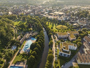 Comprehensive aerial view of a municipal outdoor swimming pool and water park, embedded in lush