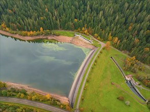 Top view of a dam wall with adjoining lake and forest in autumn atmosphere, Nagoldtalsperre, Black