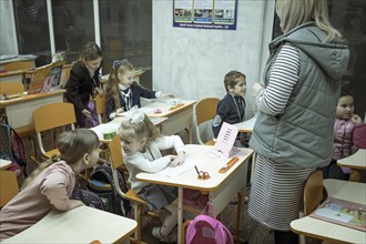 Pupils in a classroom in one of the metro schools in Kharkiv. Classrooms were set up in various