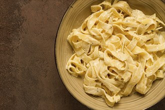 Fettuccine, tagliatelle, in creamy garlic sauce, Italian traditional cuisine, pasta carbonaro