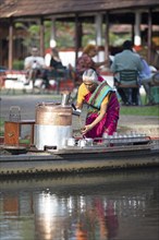 Tealady, 83 years old, making Indian tea on her boat, Backwaters, Kumarakom, Kerala, India, Asia