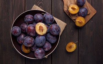 Blue plum, on a wooden table, top view, close-up, no people