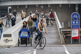 Cyclists on the Bryggebroen cycle and footpath bridge over the harbour, Sydhavnen, Copenhagen is