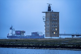 Thick fog in winter, hangs over the mouth of the Elbe into the North Sea, container ship runs into