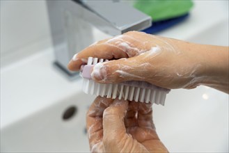 Domestic hygiene, washing hands, with a bar of soap, boy 9 years old