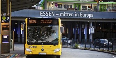 Essener Verkehrsbetriebe bus at the main railway station with local train, public transport,